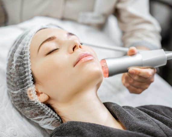 Woman during the oxygen mesotherapy procedure at the beauty salon, close-up view. Concept of a professional facial treatment