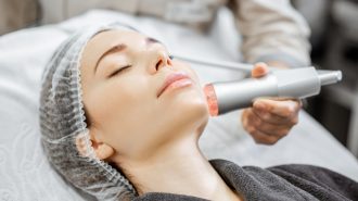 Woman during the oxygen mesotherapy procedure at the beauty salon, close-up view. Concept of a professional facial treatment